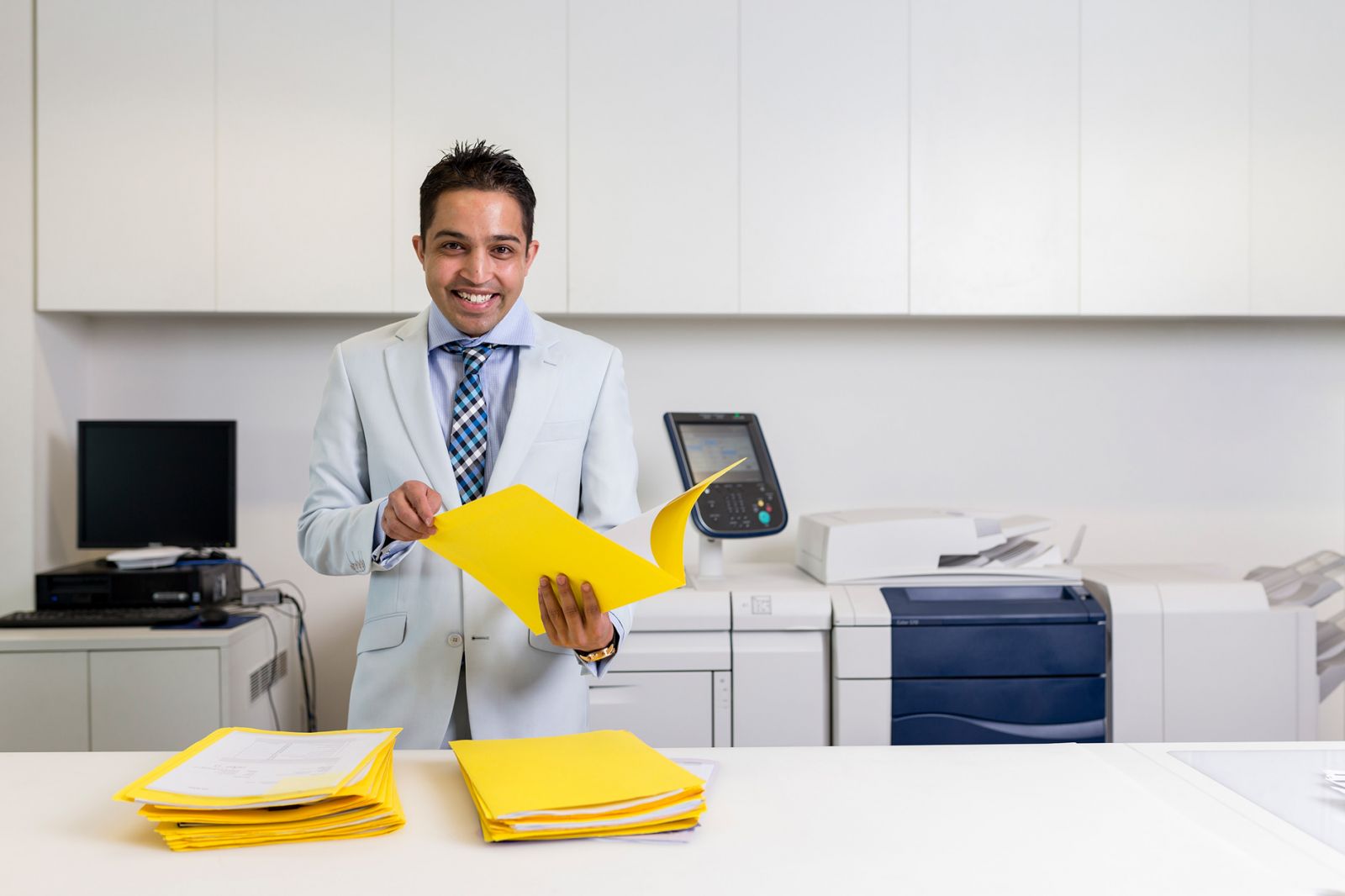Smiling man holding folders
